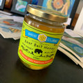 Jar of Bear Bait Honey with a visible label on a dark surface